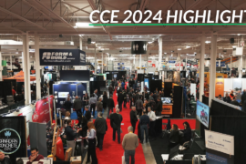 A crowd of people on a show floor next to concrete hardware.